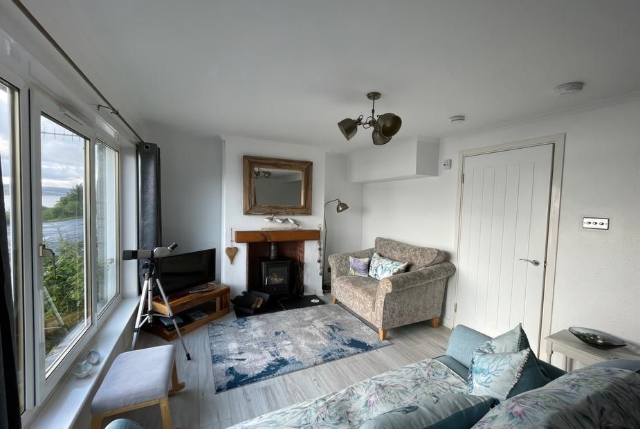 Pier View living room with telescope by the window overlooking Loch Long, Blairmore