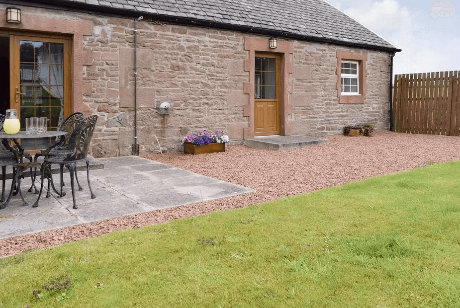 The Stables traditional stone building with patio dining area on gravel, Gartmore