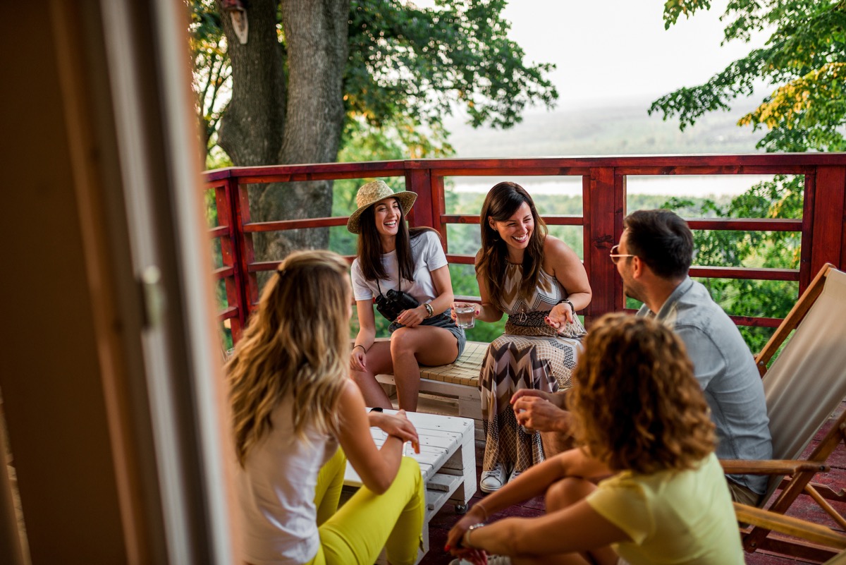 Group of friends enjoying a lodge deck holiday