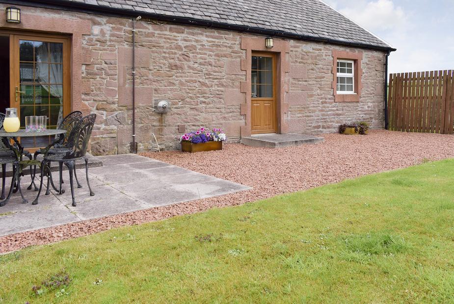 The Stables traditional stone building with patio dining area on gravel, Gartmore